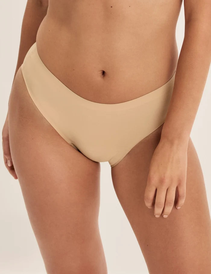 Megan has 36.5” hips and wears KNIX S | Front view of model wearing the Super Leakproof® No-Show French Cut highlighting the coverage and smooth fit | Warm Sand