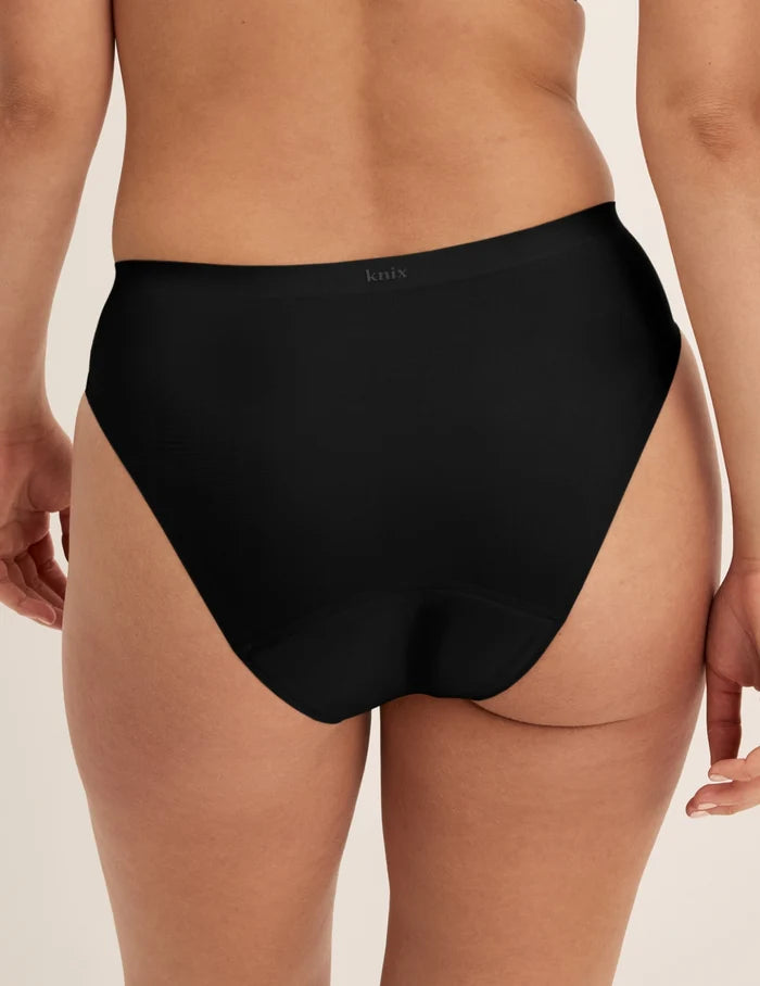 Megan has 36.5” hips and wears KNIX S | Back view of model wearing the Super Leakproof® No-Show French Cut highlighting the coverage and smooth fit | Black