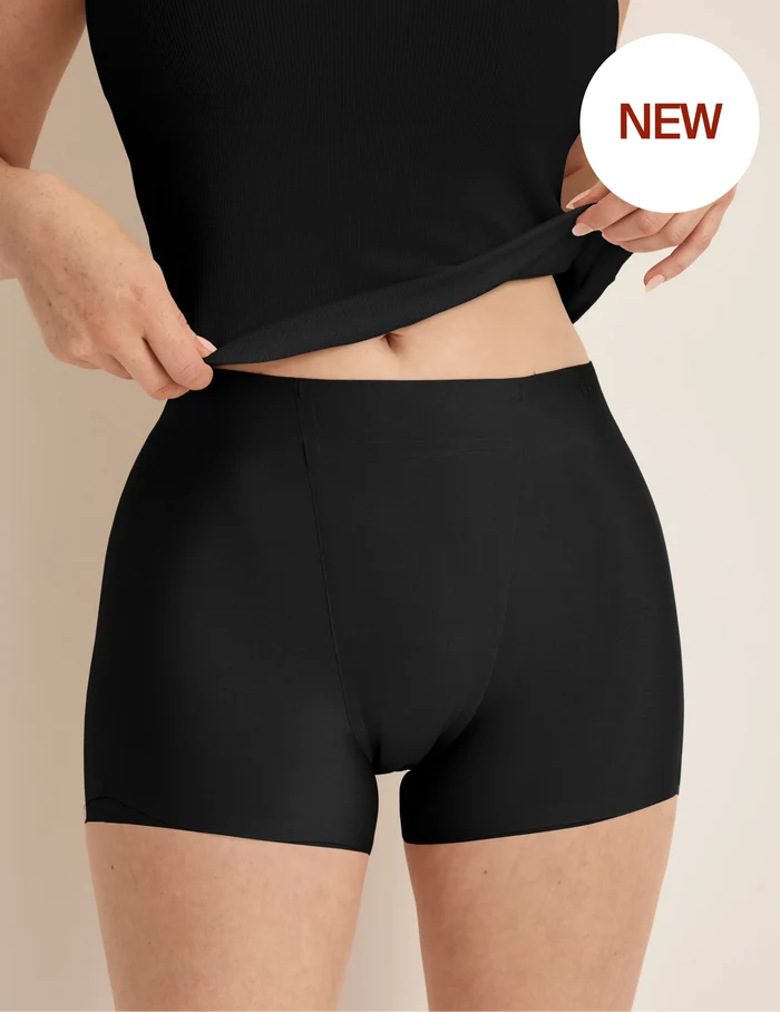 | Front view of model wearing the SuperPlus Leakproof® Dream Short highlighting the coverage and smooth fit | Black