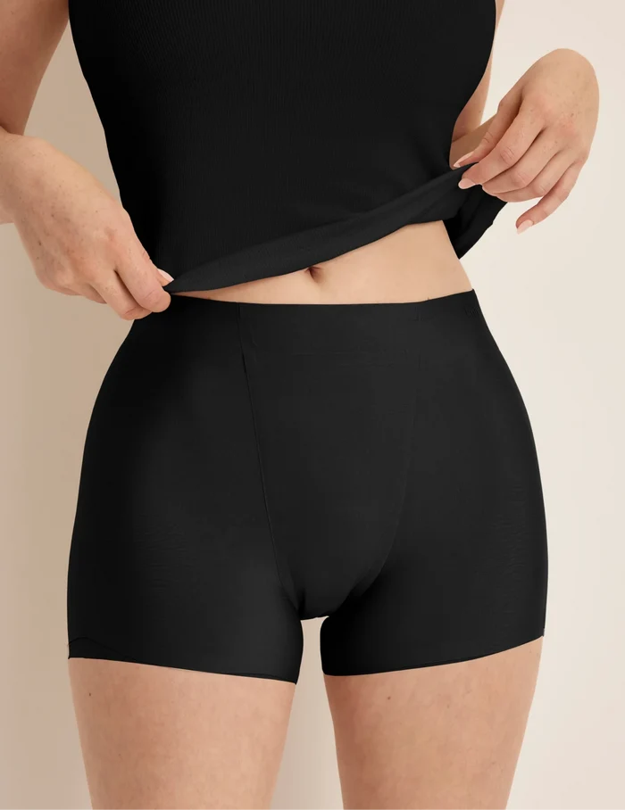 | Front view of model wearing the SuperPlus Leakproof® Dream Short highlighting the coverage and smooth fit | Black