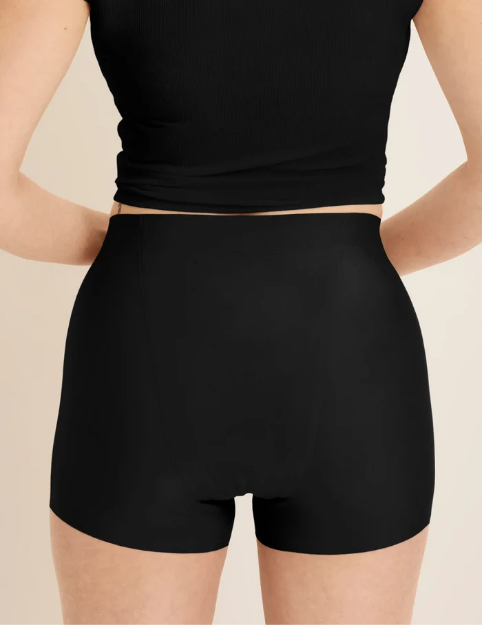 | Back view of model wearing the SuperPlus Leakproof® Dream Short highlighting the coverage and smooth fit | Black