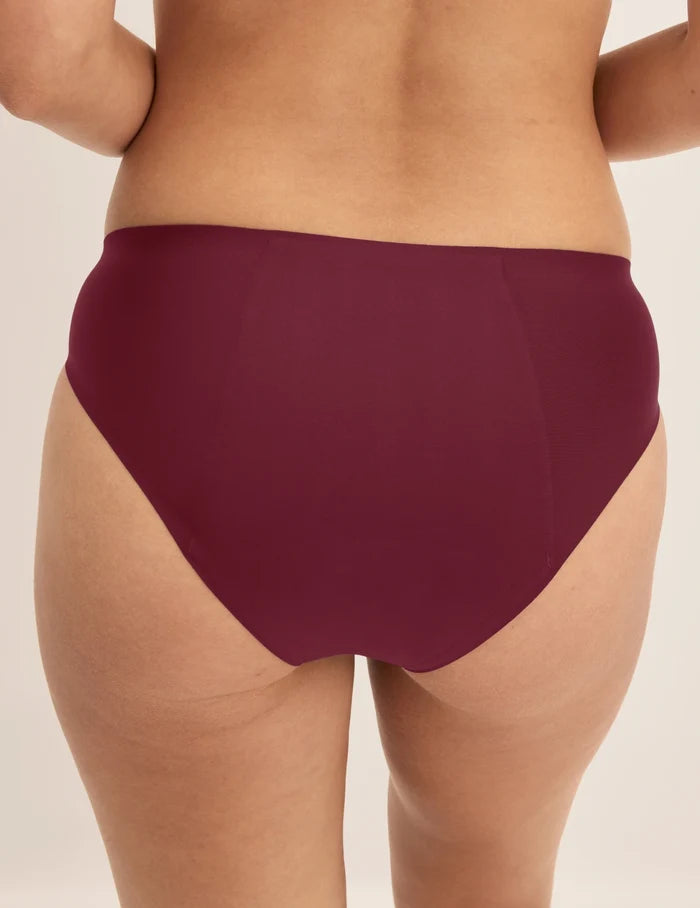 Megan has 36.5” hips and wears KNIX S | Back view of model wearing the SuperPlus Leakproof® No-Show Bikini highlighting the coverage and smooth fit | Dark Cherry