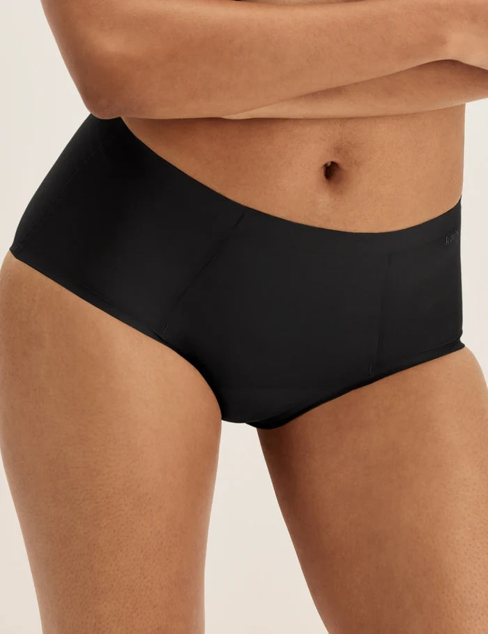 Ashley has 39” hips and wears KNIX S | Front view of model wearing the SuperPlus Leakproof® No-Show Boybrief highlighting the coverage and smooth fit | Black