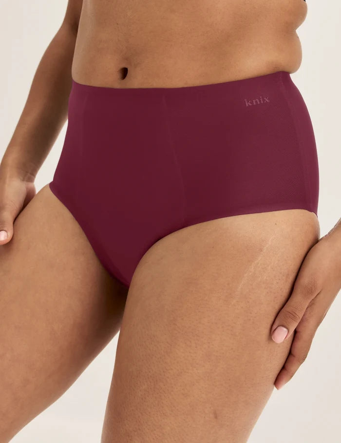 Ashley has 39” hips and wears KNIX S | Front view of model wearing the SuperPlus Leakproof® No-Show High Rise highlighting the coverage and smooth fit | Dark Cherry