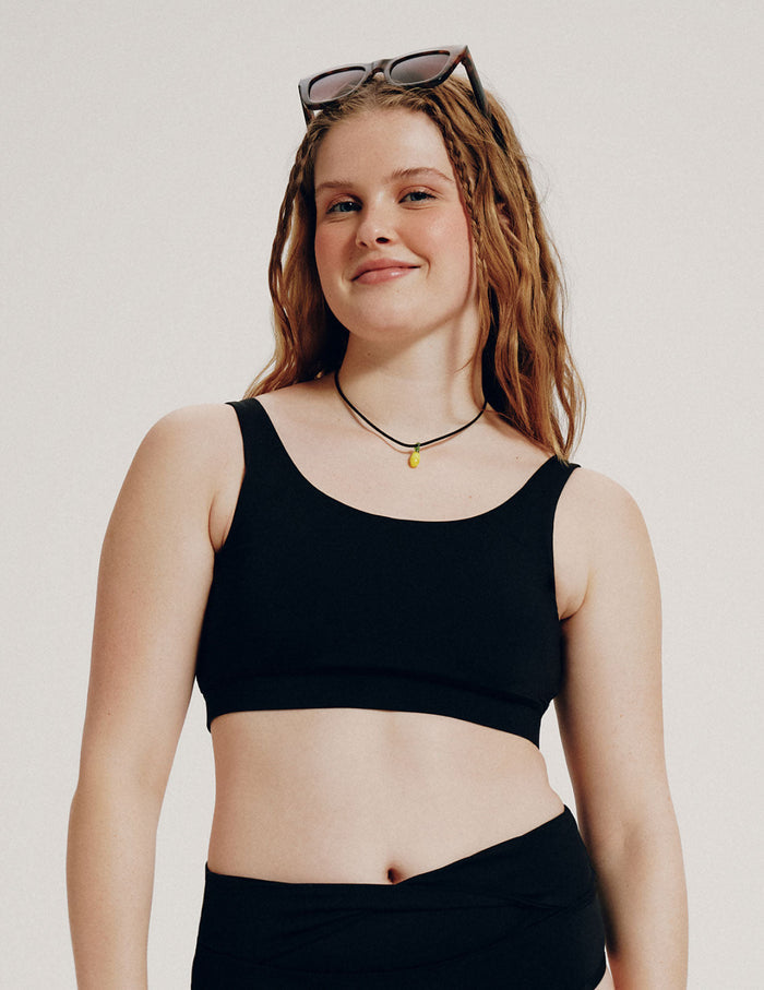 | Front view of model wearing the Teen Double Scoop Bikini Top highlighting the neckline, strap design, and silhouette | Black