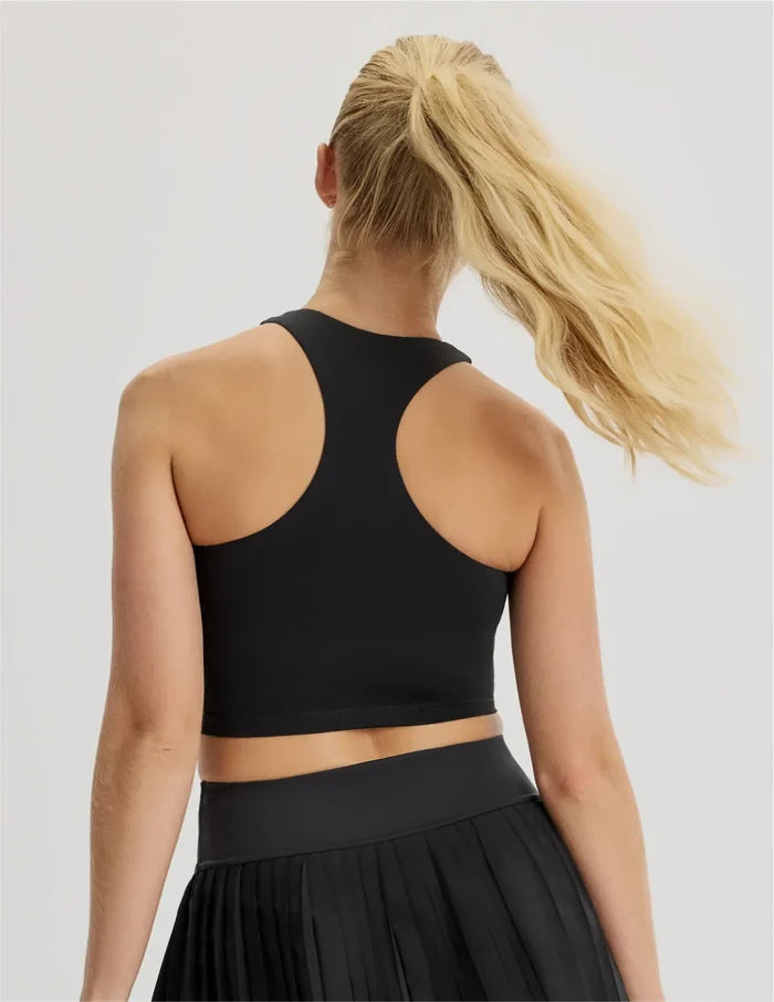 | Back view of model wearing the Teen First Serve Racerback Tank highlighting the coverage and fit | Black