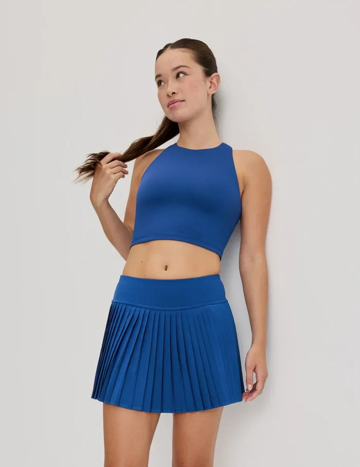 | Front view of model wearing the Teen First Serve Racerback Tank highlighting the coverage and fit | Shady Blue