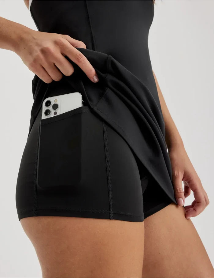 | Front view of model wearing the Teen First Serve Sport Dress highlighting the coverage and fit | Black