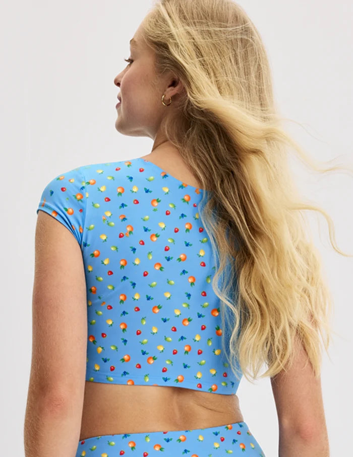 | Back view of model wearing the Teen High Tide Cropped Swim Top highlighting the coverage and fit | Fresh Fruit