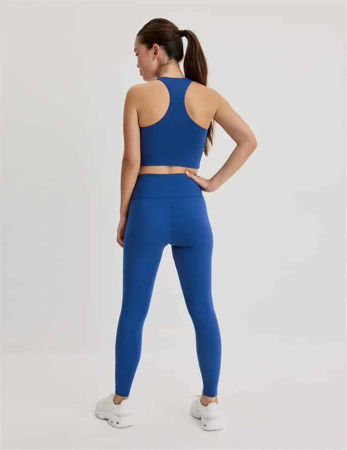 | Back view of model wearing the Teen Leakproof Active Legging highlighting the coverage and fit | Shady Blue