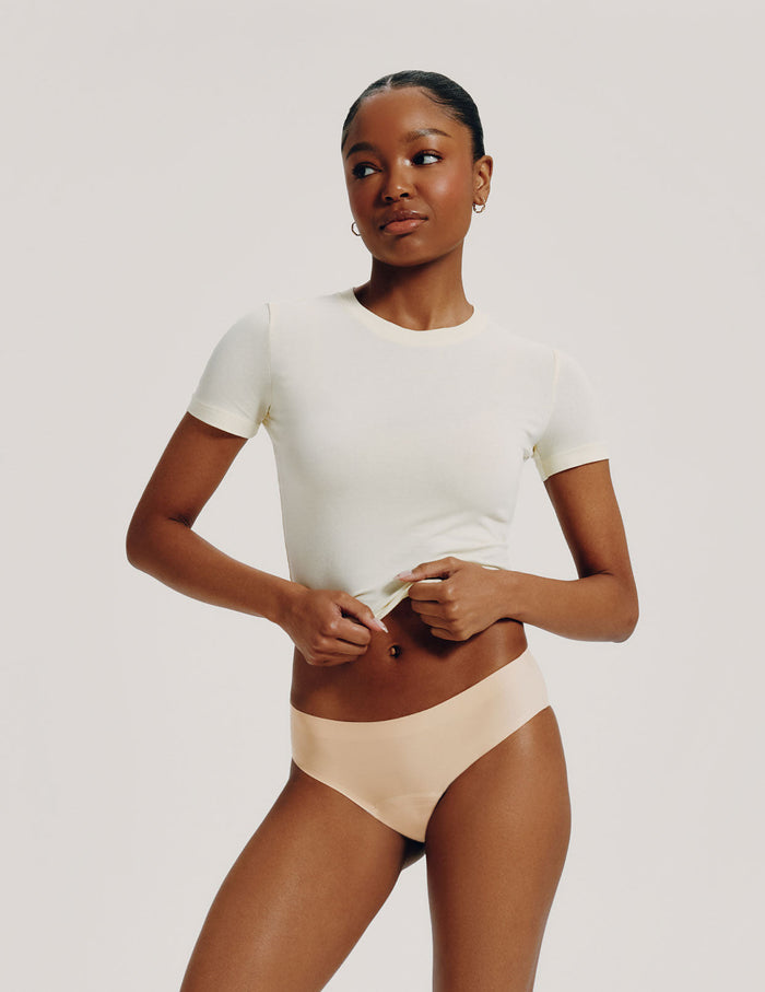 | Front view of model wearing the Teen Leakproof UltraThin No-Show Bikini highlighting the coverage and smooth fit | Warm Sand