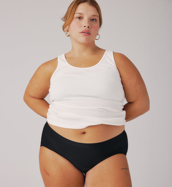 | Front view of model wearing the Teen Light Leakproof No-Show Boyshort highlighting the coverage and smooth fit | Black