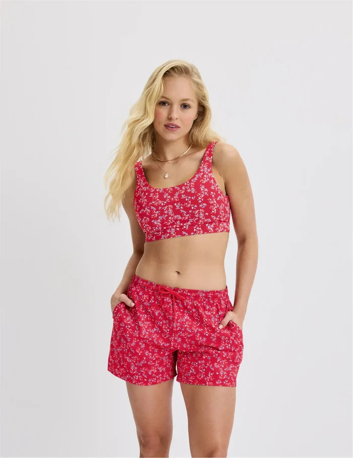 | Front view of model wearing the Teen Period Swim Board Shorts highlighting the coverage and fit | Poppy Petal