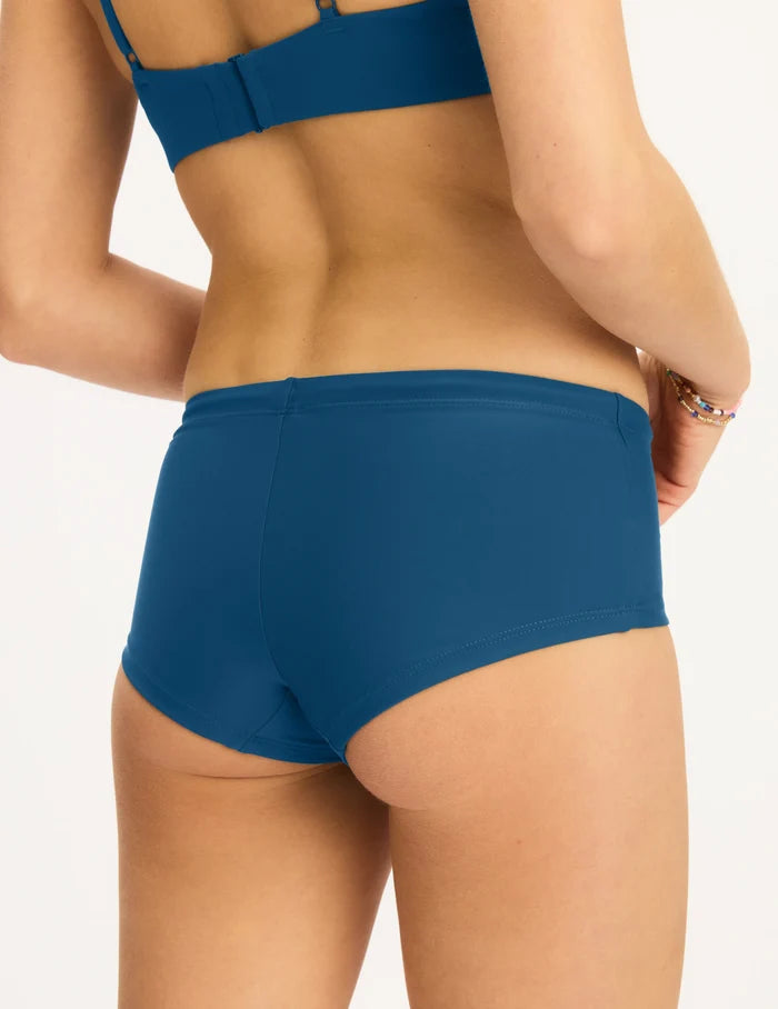 | Back view of model wearing the Teen Period Swim Full Coverage Hipster highlighting the coverage and fit | Blue Coast