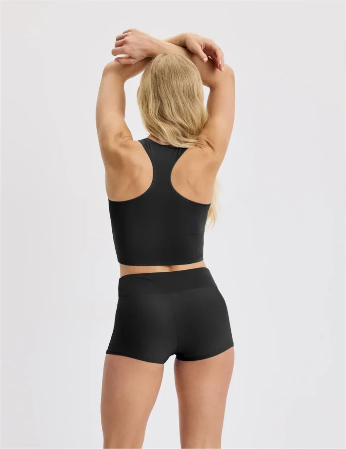| Back view of model wearing the Teen Racerback Tankini Swim Top highlighting the coverage and fit | Black