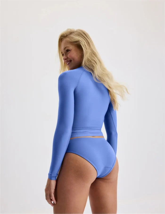 | Back view of model wearing the Teen Sunny Skies Rash Guard highlighting the coverage and fit | Wave Pool