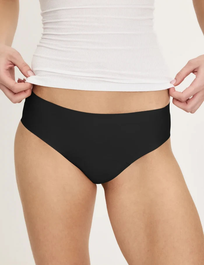 | Front view of model wearing the Teen Super Leakproof® No-Show Bikini highlighting the coverage and smooth fit | Black