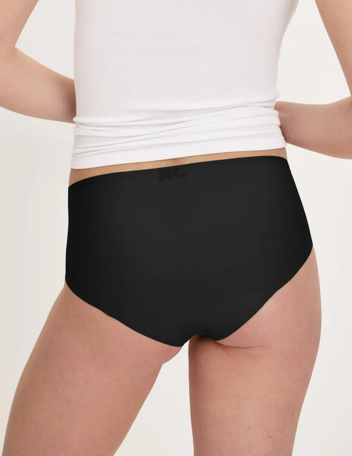 | Back view of model wearing the Teen Super Leakproof® No-Show Boyshort highlighting the coverage and smooth fit | Black