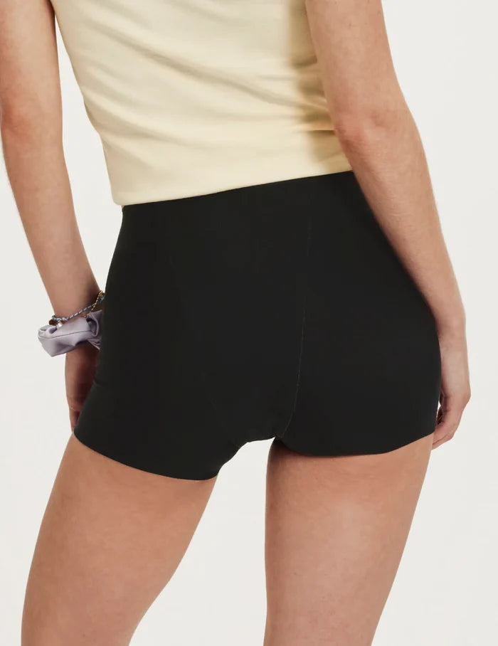 | Back view of model wearing the Teen SuperPlus Leakproof® Sleepover Short highlighting the coverage and smooth fit | Black