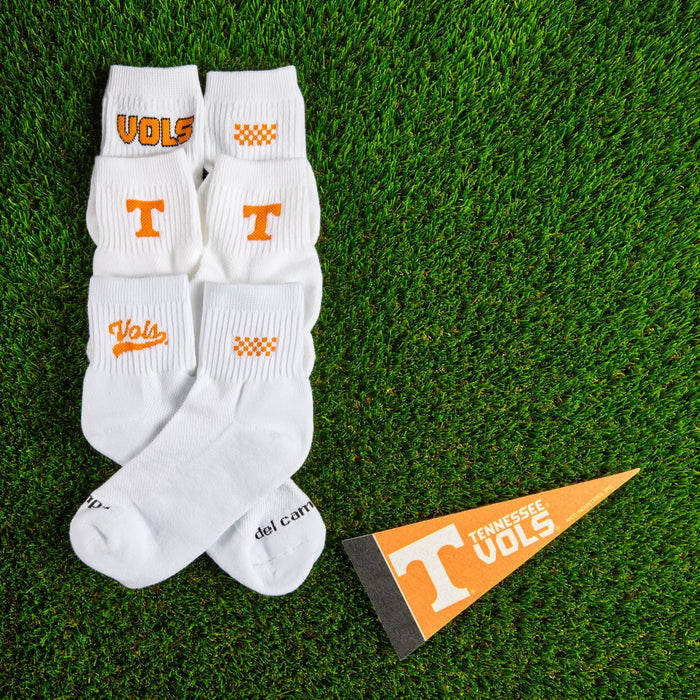 Flat lay of Del Campo Tennessee Pack golf socks with game-day props