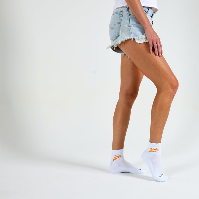 Woman wearing Del Campo Tennessee Script golf socks, studio shot, no shoes