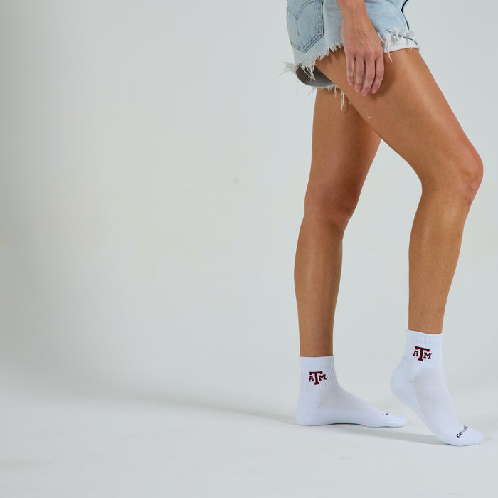Woman wearing Del Campo Texas A&M Aggies golf socks, studio shot, no shoes