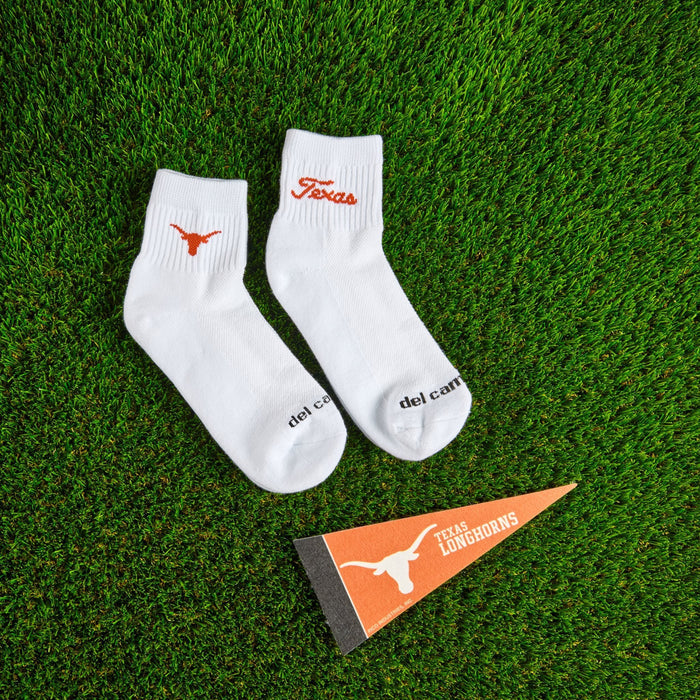 Flat lay of Del Campo Texas Longhorns Pack golf socks with game-day props