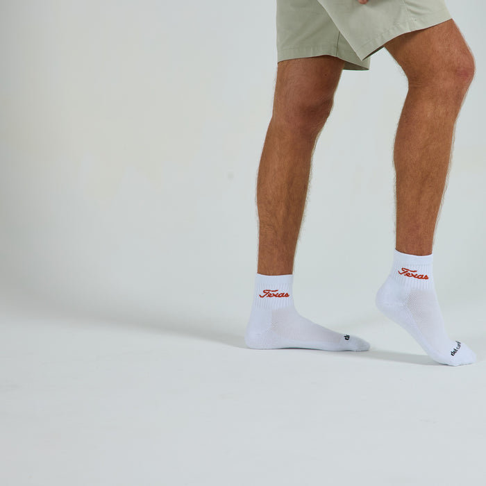 Man wearing Del Campo Texas Longhorns Script golf socks, studio shot, no shoes