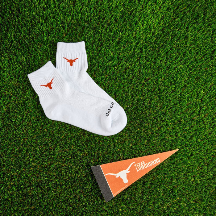 Del Campo Texas Longhorns golf socks on turf with a team pennant