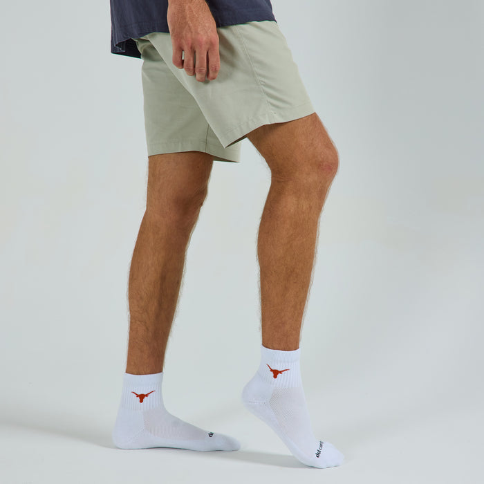 Man wearing Del Campo Texas Longhorns golf socks, studio shot, no shoes