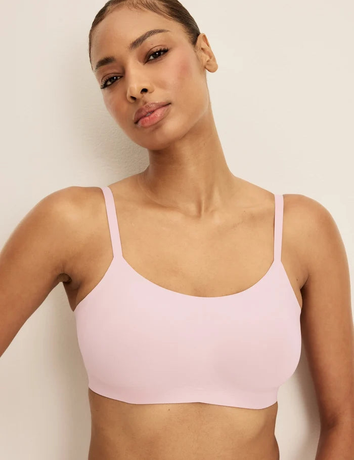 Ashley is a 32DD and wearing KNIX S+ | Front view of model wearing the Revolution Scoop Bra, highlighting the neckline, strap design, and smooth silhouette | Rose Water