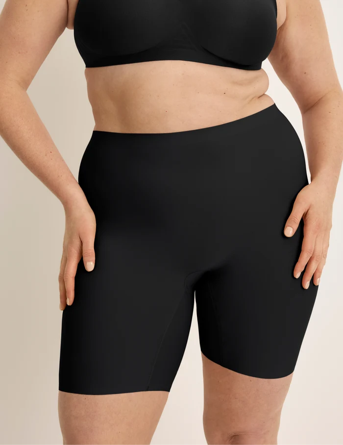 Beatrice is wearing KNIX XL | Front view of model wearing the Thigh Saver® 6” highlighting the coverage and smooth fit | Black