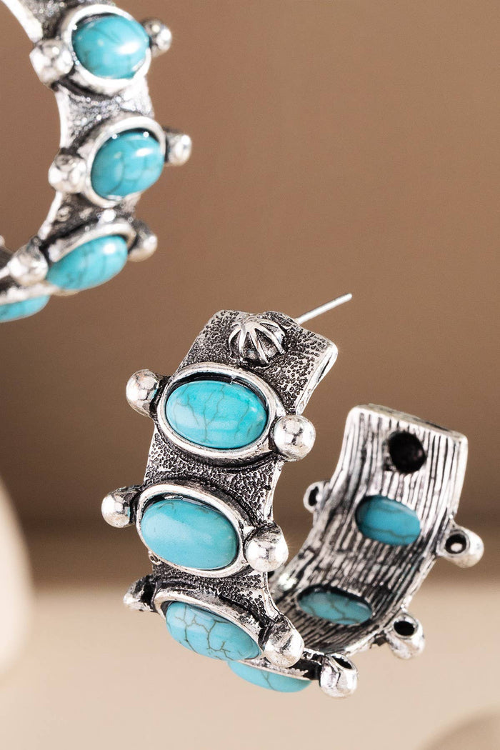 Chunky half hoops set with oval turquoise style cabochons and oxidized rope detailing for a bold Western look.