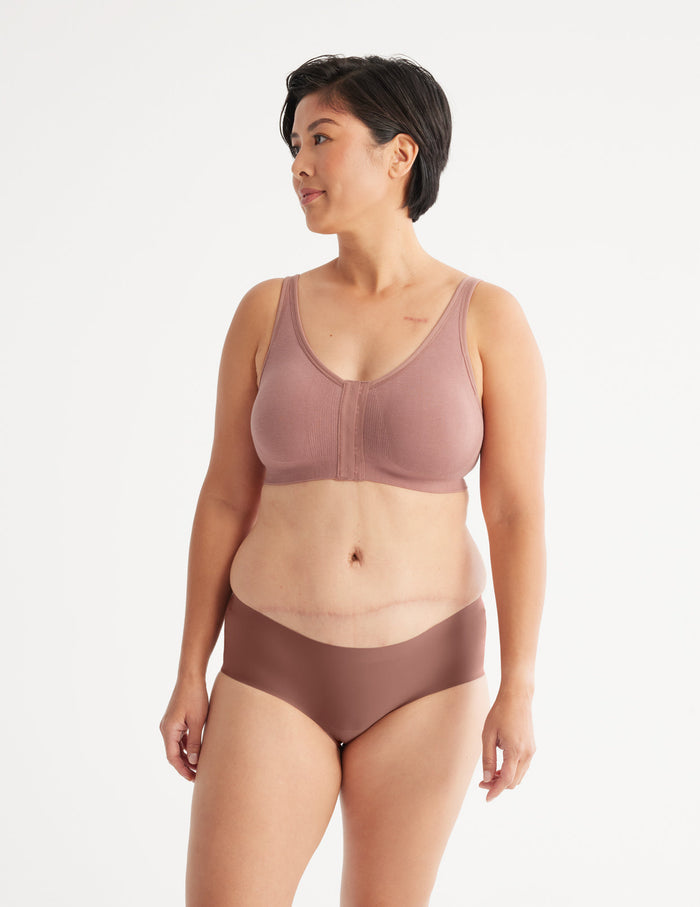 Denise is a customer and wears a Knix size M | Full-body view of model wearing the Ultra Soft Front Closure Bra, highlighting the neckline, easy front closure, and seamless knit silhouette| Bisque