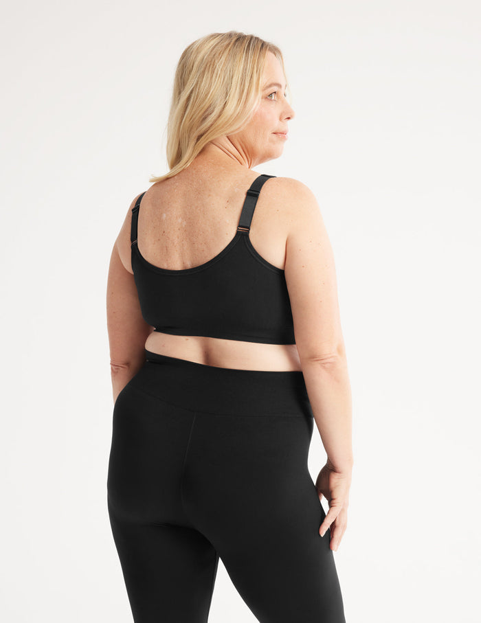 Kimberly is a customer and wears a Knix size L | Back view of model wearing the Ultra Soft Front Closure Bra, highlighting the neckline, easy front closure, and seamless knit silhouette| Black