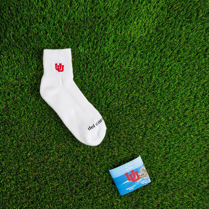 Flat lay of Del Campo Utah Utes golf socks with game-day props