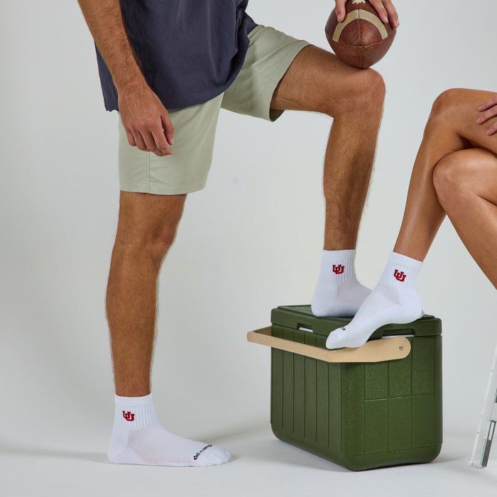 Two models wearing Del Campo Utah Utes golf socks in studio