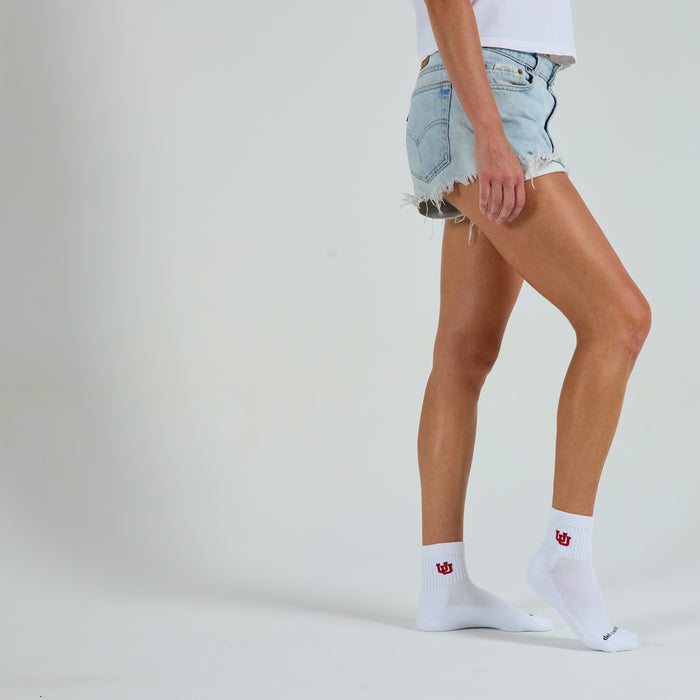 Woman wearing Del Campo Utah Utes golf socks, studio shot, no shoes