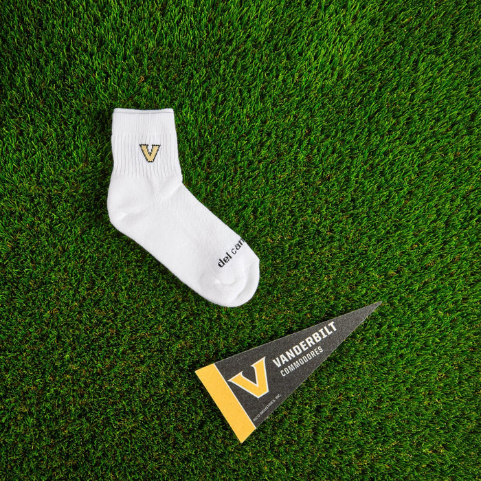Flat lay of Del Campo Vanderbilt Commodores golf socks with game-day props