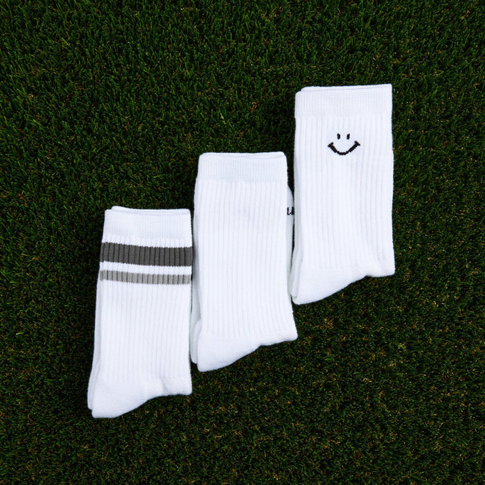 Del Campo Variety Crew 3-Pack golf socks featuring one grey stripe, one blank, and one smiley crew sock