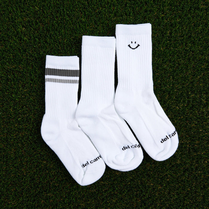 Del Campo Variety Crew 3-Pack golf socks featuring one grey stripe, one blank, and one smiley crew sock