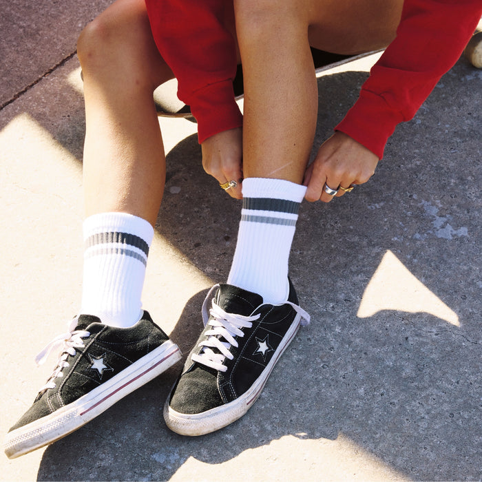 Del Campo Variety Crew 3-Pack golf socks featuring one grey stripe, one blank, and one smiley crew sock