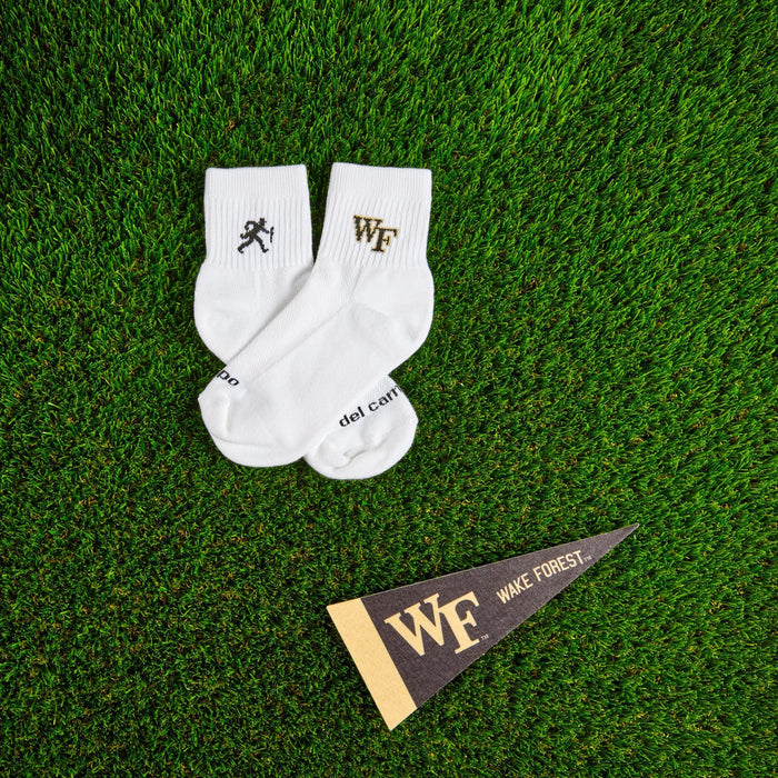 Del Campo Wake Forest Walking Deacon golf socks on turf with a team pennant