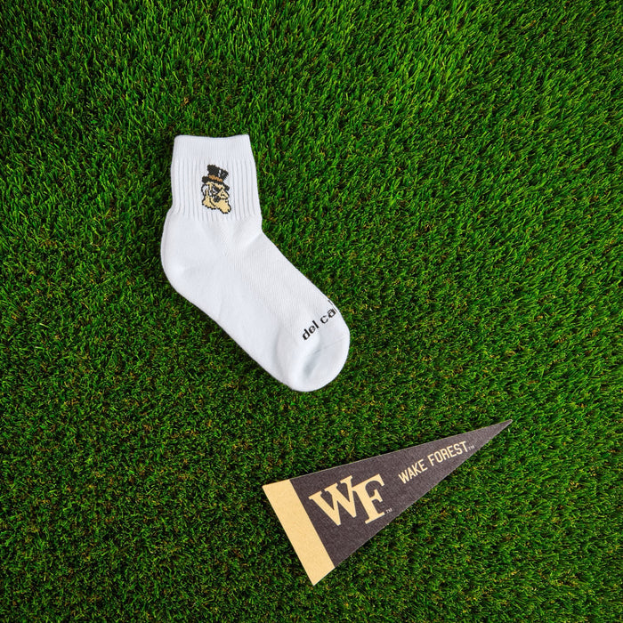 Flat lay of Del Campo Wake Forest Demon Deacons golf socks with game-day props