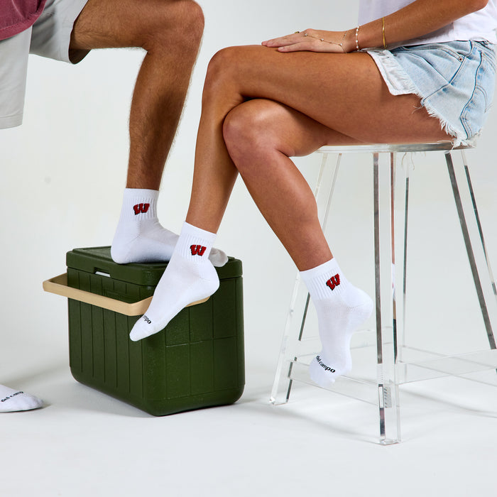 Two models wearing Del Campo Wisconsin Badgers golf socks in studio
